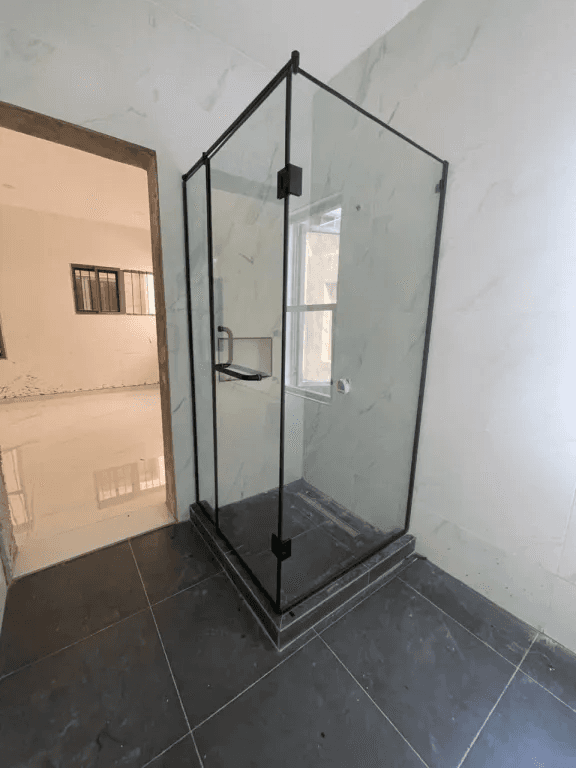 Frameless shower enclosure